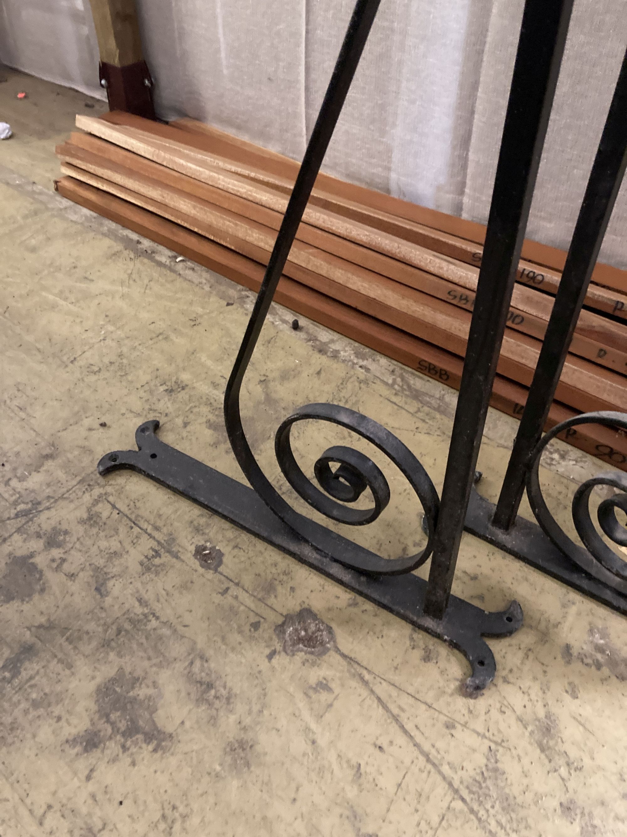 A pair of black painted wrought iron wall mounting brackets, width 114cm, height 54cm